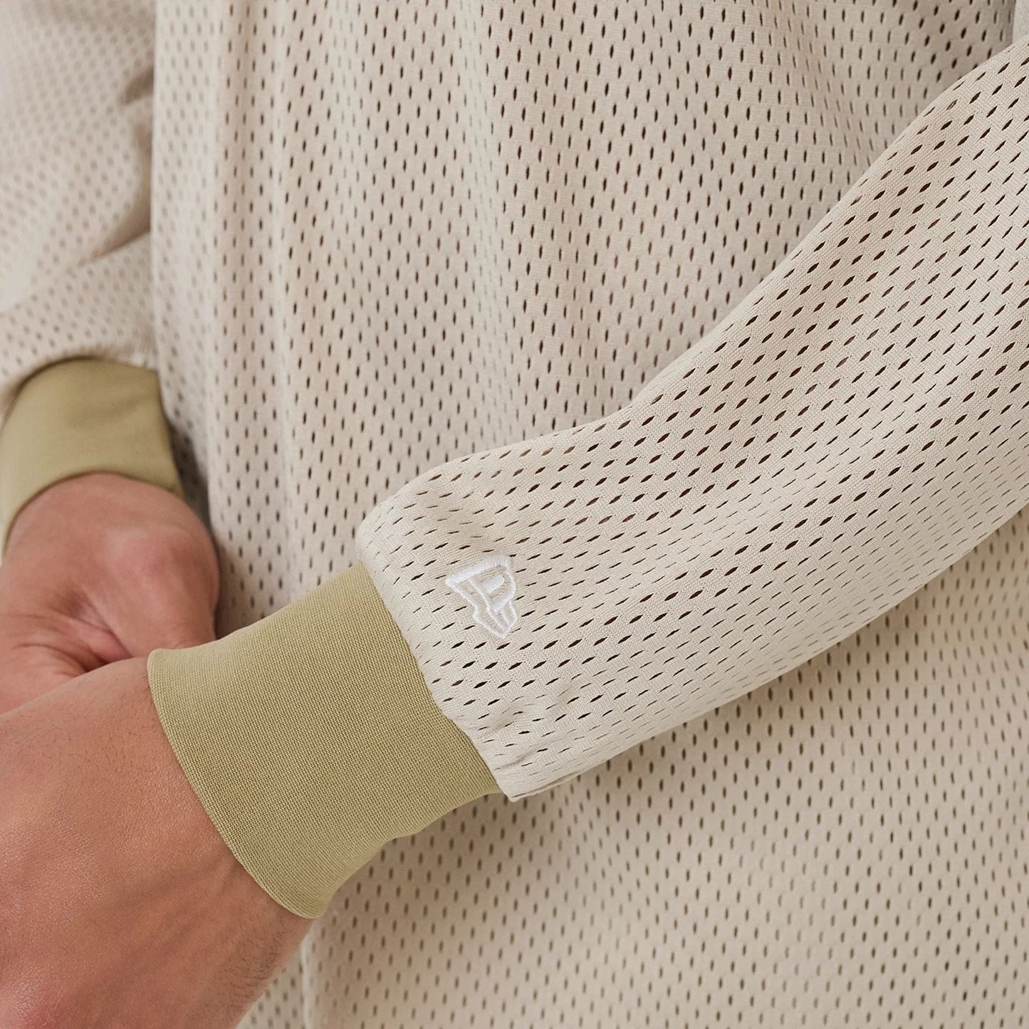 The model is wearing this New Era NEC Logo Long Sleeve Jersey in beige/khaki. 6