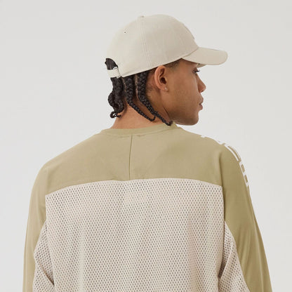 The model is wearing this New Era Urban Core Long Sleeve Jersey in beige/khaki. 7