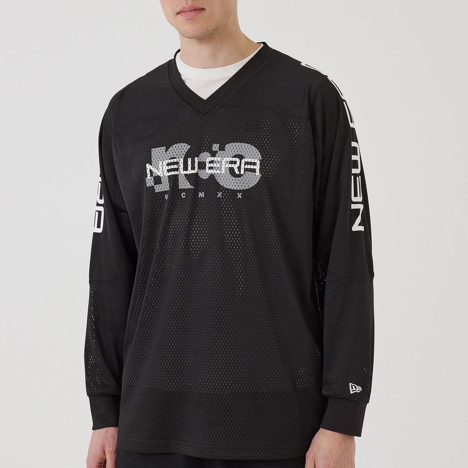 The model is wearing this New Era Urban Core Long Sleeve Jersey in black. 6