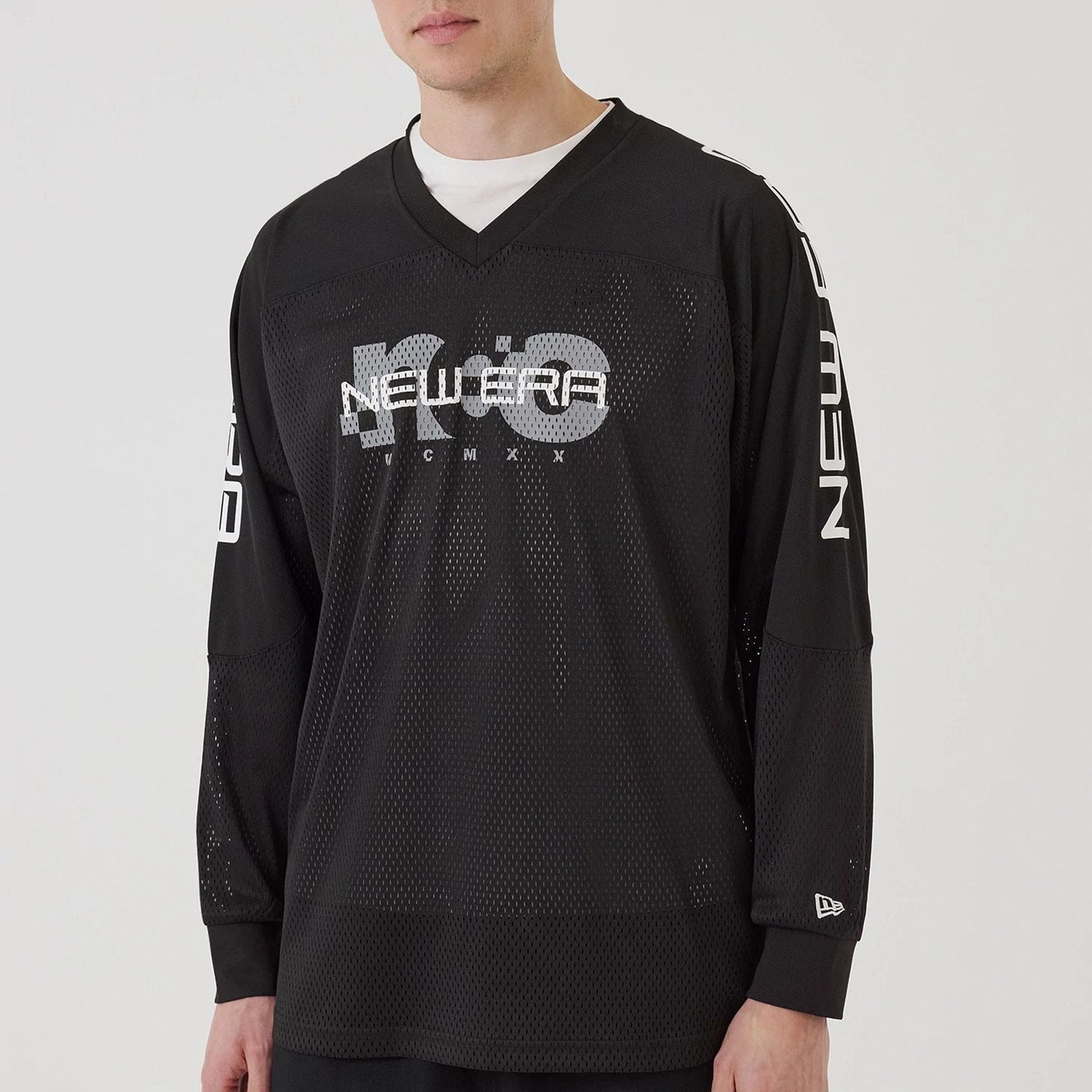 The model is wearing this New Era NEC Logo Long Sleeve Jersey in black. 6