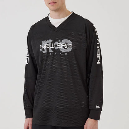 The model is wearing this New Era NEC Logo Long Sleeve Jersey in black. 6