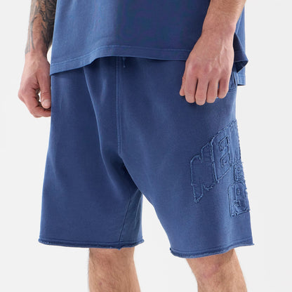 The model is wearing this New Era Street Archived Oversized Shorts in blue. 3