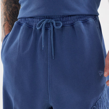 The model is wearing this New Era Street Archived Oversized Shorts in blue. 4