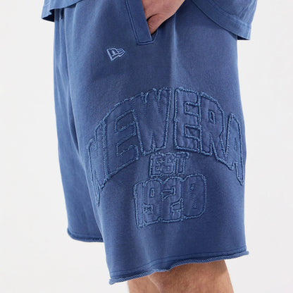 The model is wearing this New Era Street Archived Oversized Shorts in blue. 5
