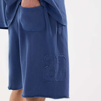 The model is wearing this New Era Street Archived Oversized Shorts in blue. 7