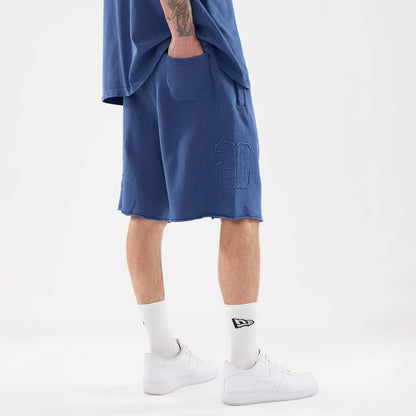 The model is wearing this New Era Street Archived Oversized Shorts in blue. 2