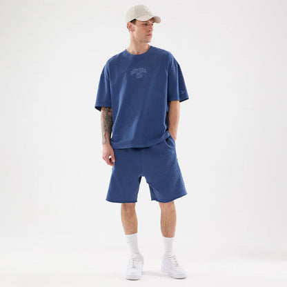 The model is wearing this New Era Street Archived Oversized Shorts in blue. 8