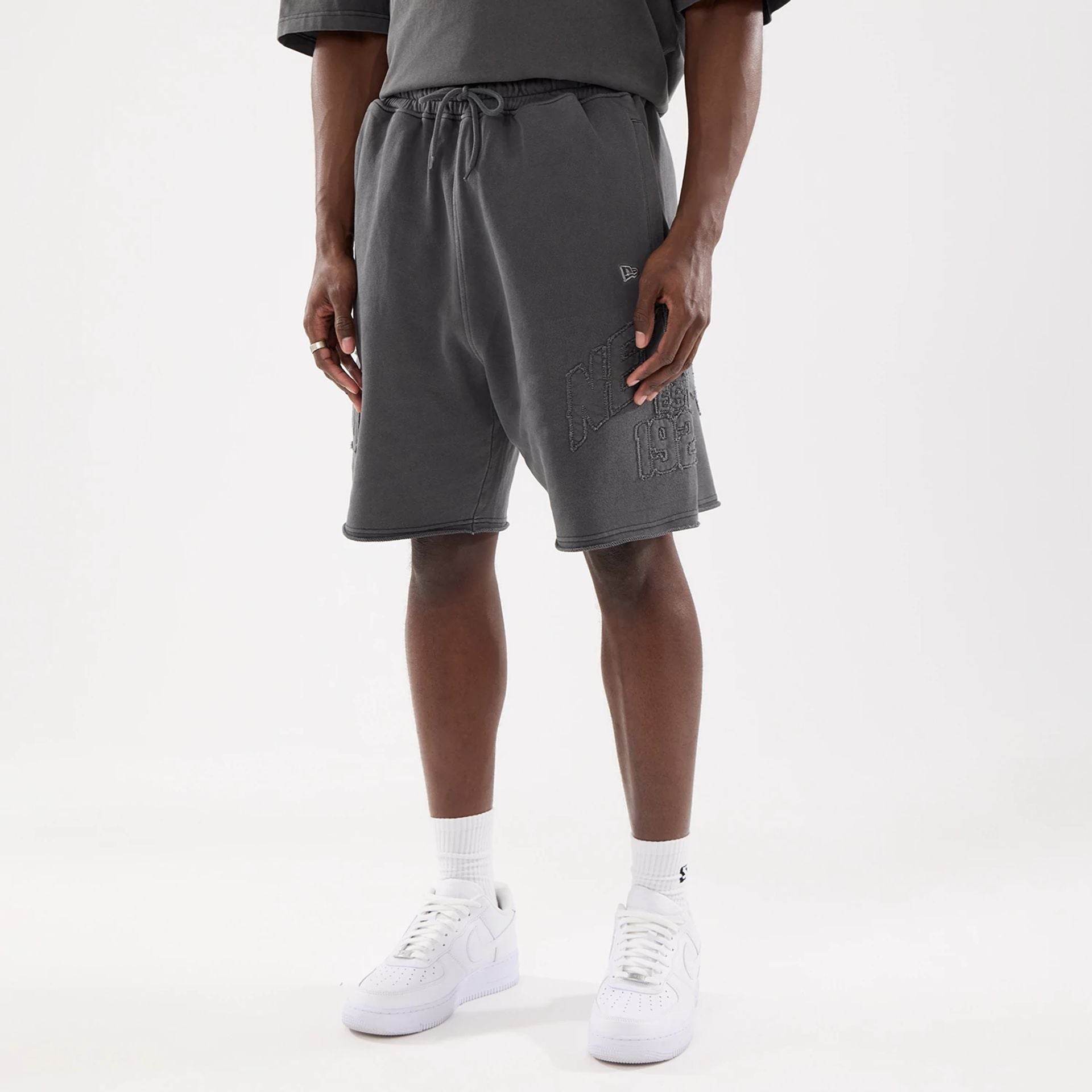The model is wearing this New Era Street Archived Oversized Shorts in black. 1