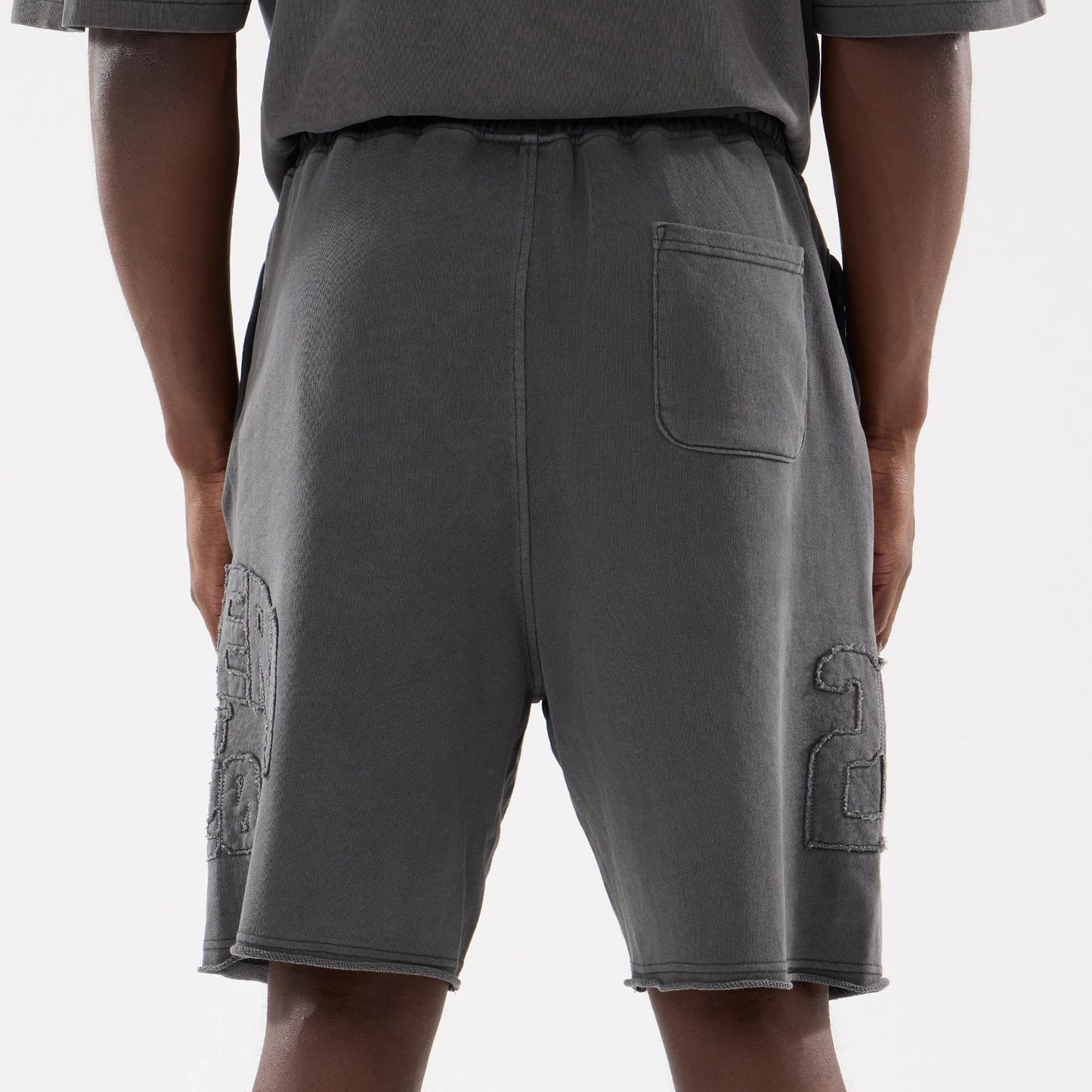 The model is wearing this New Era Street Archived Oversized Shorts in black. 7