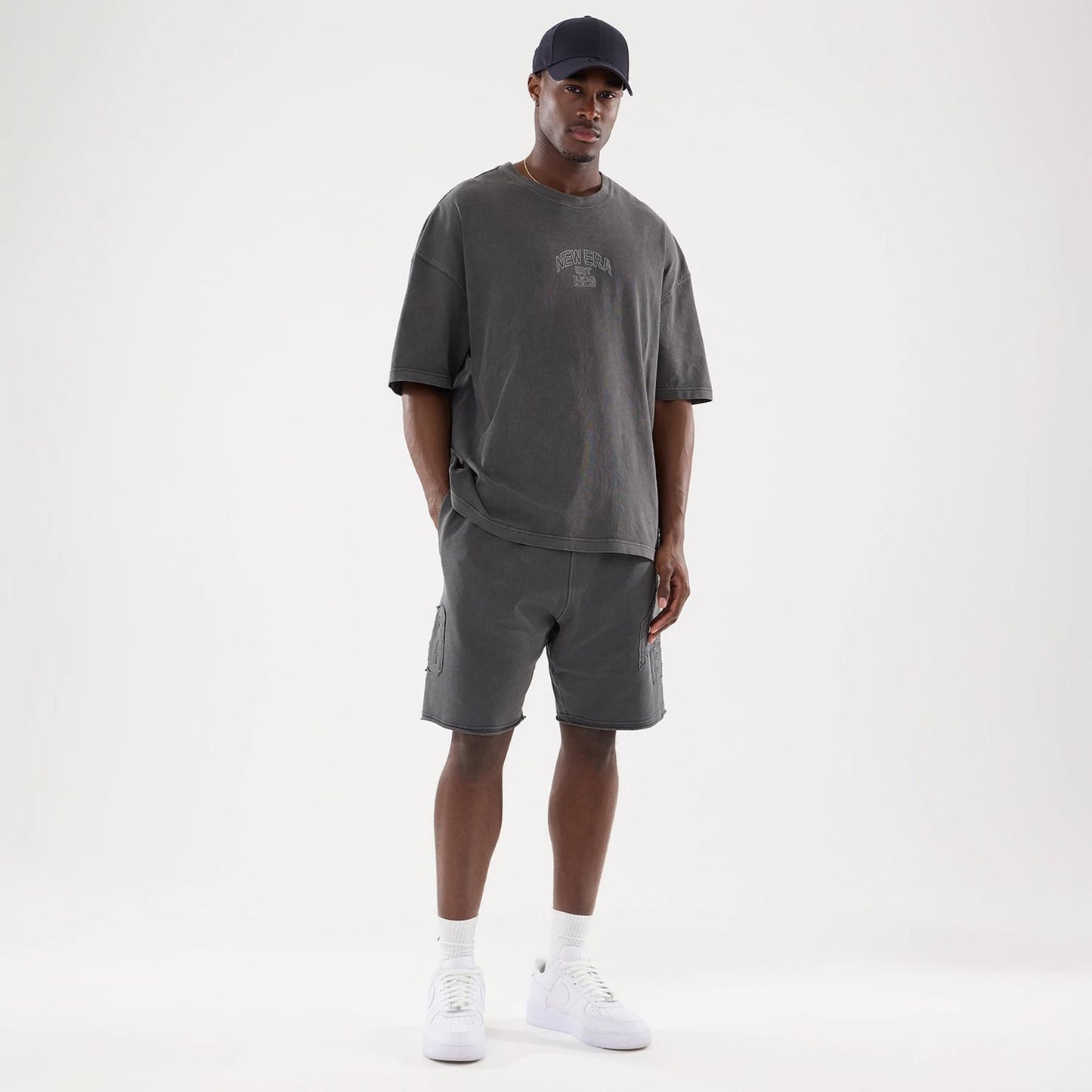 The model is wearing this New Era Street Archived Oversized Shorts in black. 8