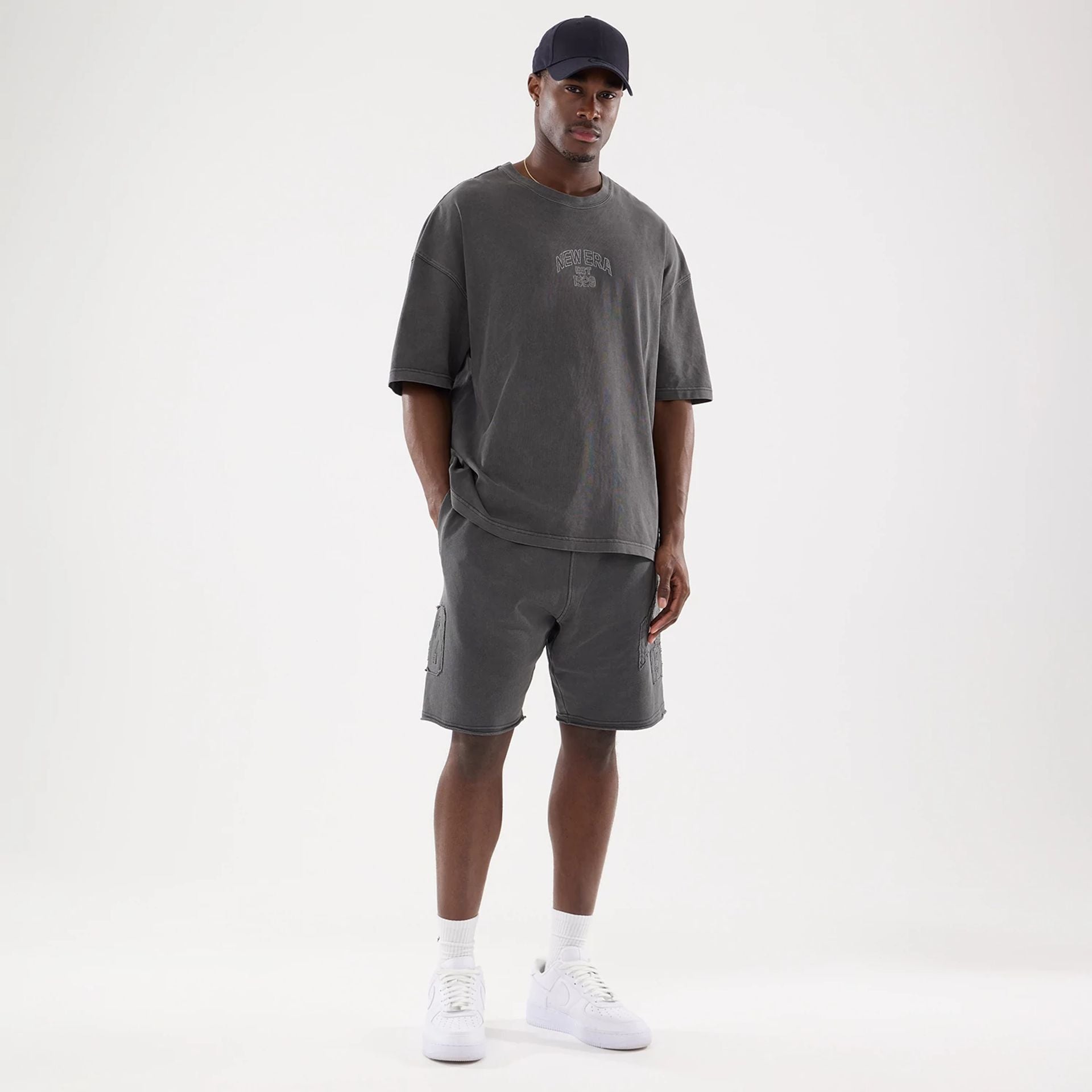 The model is wearing this New Era Street Archived Oversized Shorts in black. 8