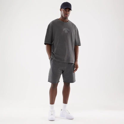 The model is wearing this New Era Street Archived Oversized Shorts in black. 8