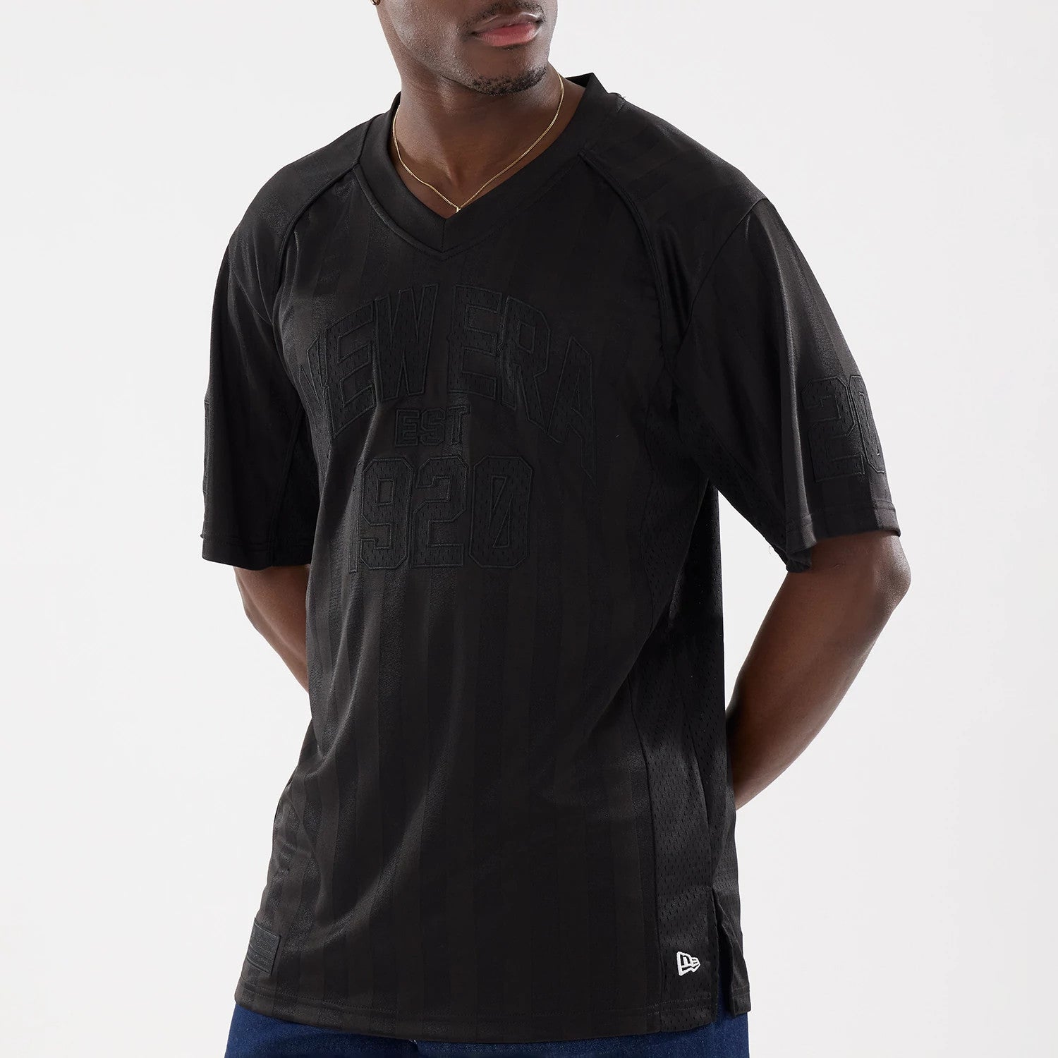 The model is wearing this New Era Street Archived Mesh Jersey in black. 3