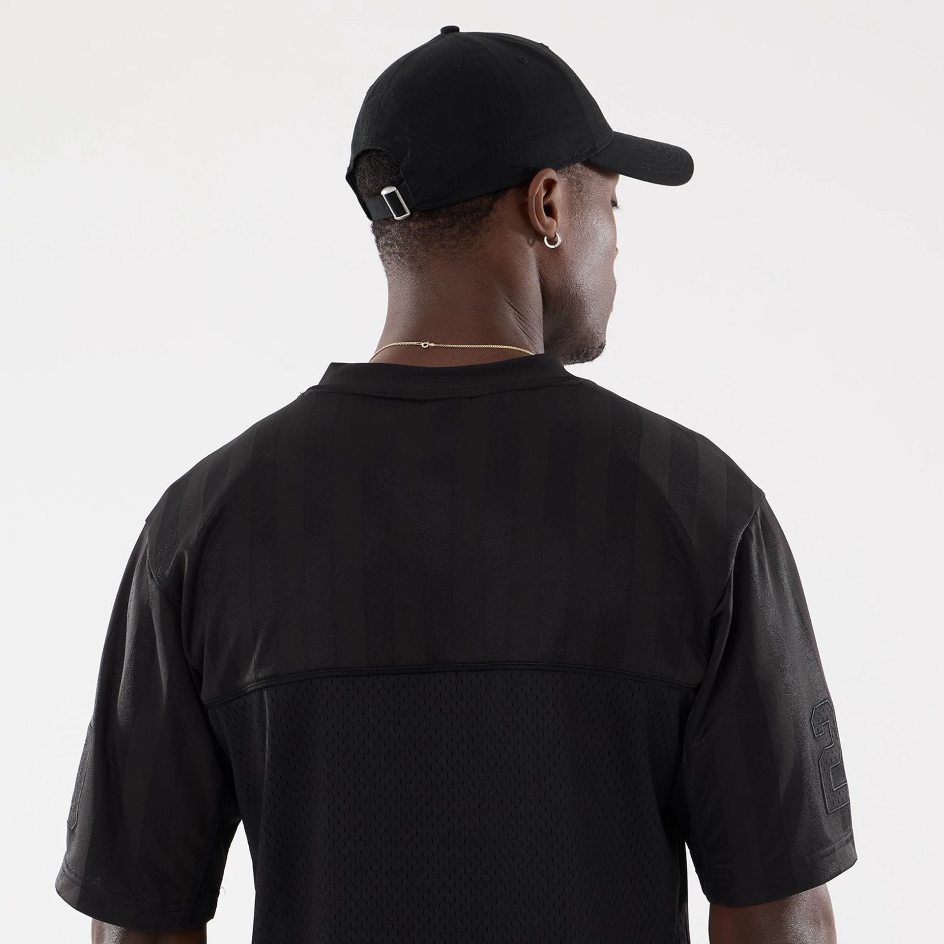 The model is wearing this New Era Street Archived Mesh Jersey in black. 7