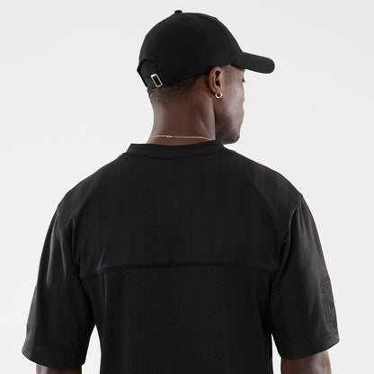 The model is wearing this New Era Street Archived Mesh Jersey in black. 7