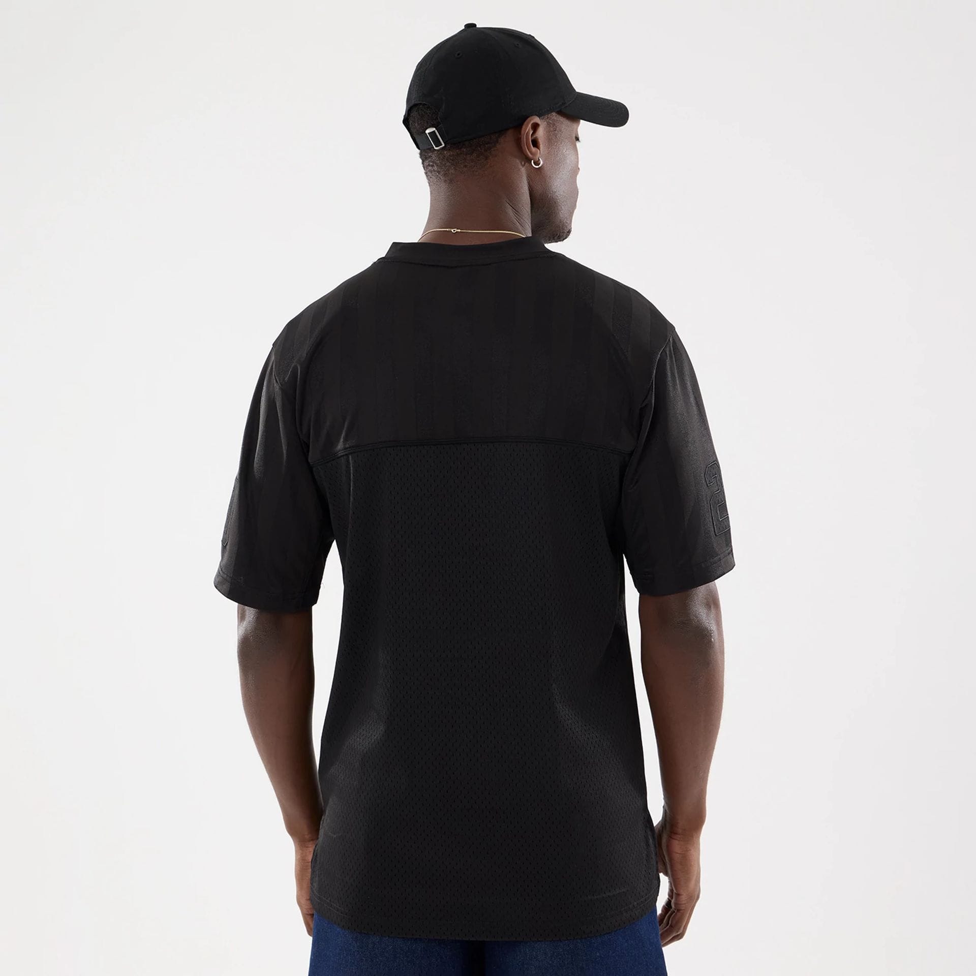 The model is wearing this New Era Street Archived Mesh Jersey in black. 2