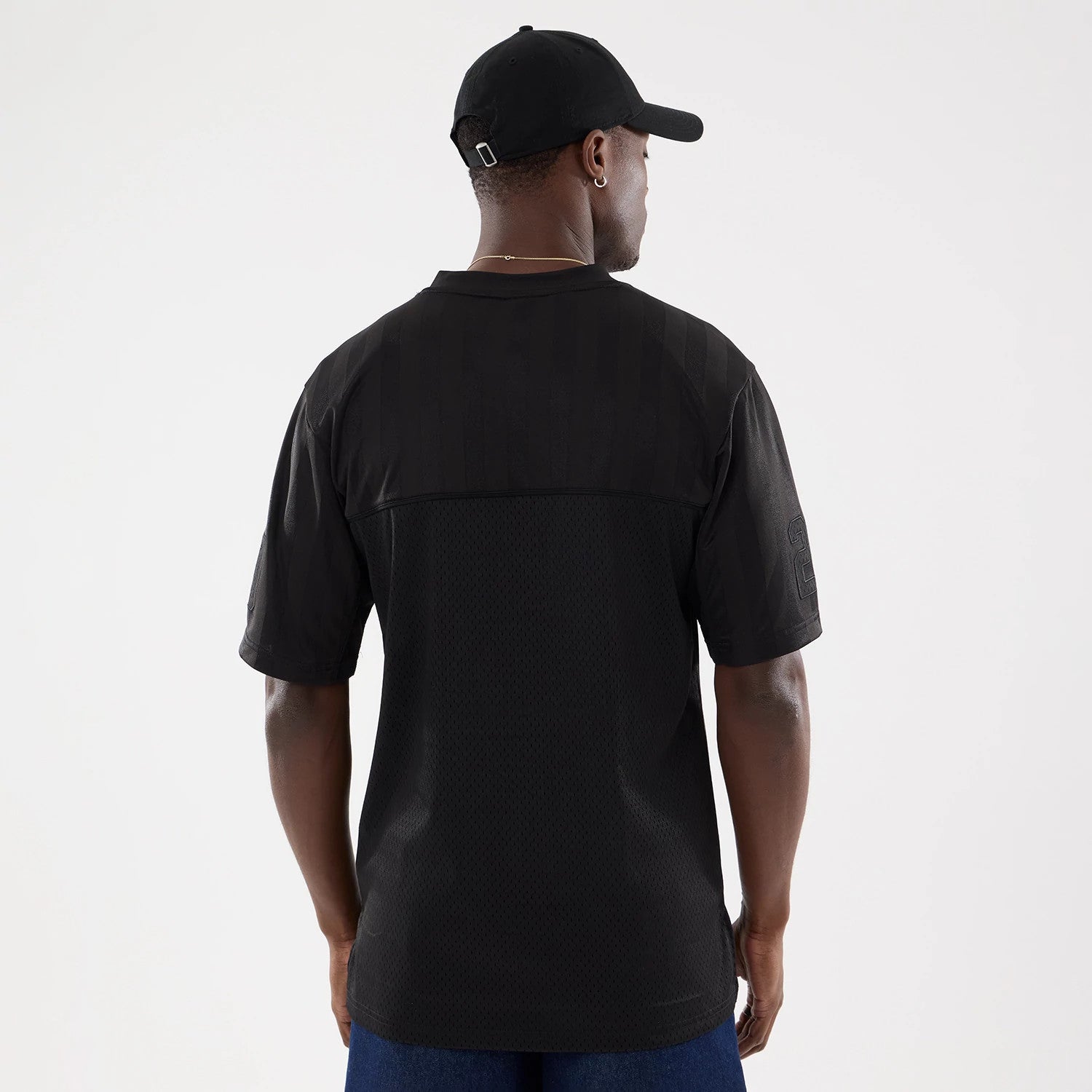 The model is wearing this New Era Street Archived Mesh Jersey in black. 2