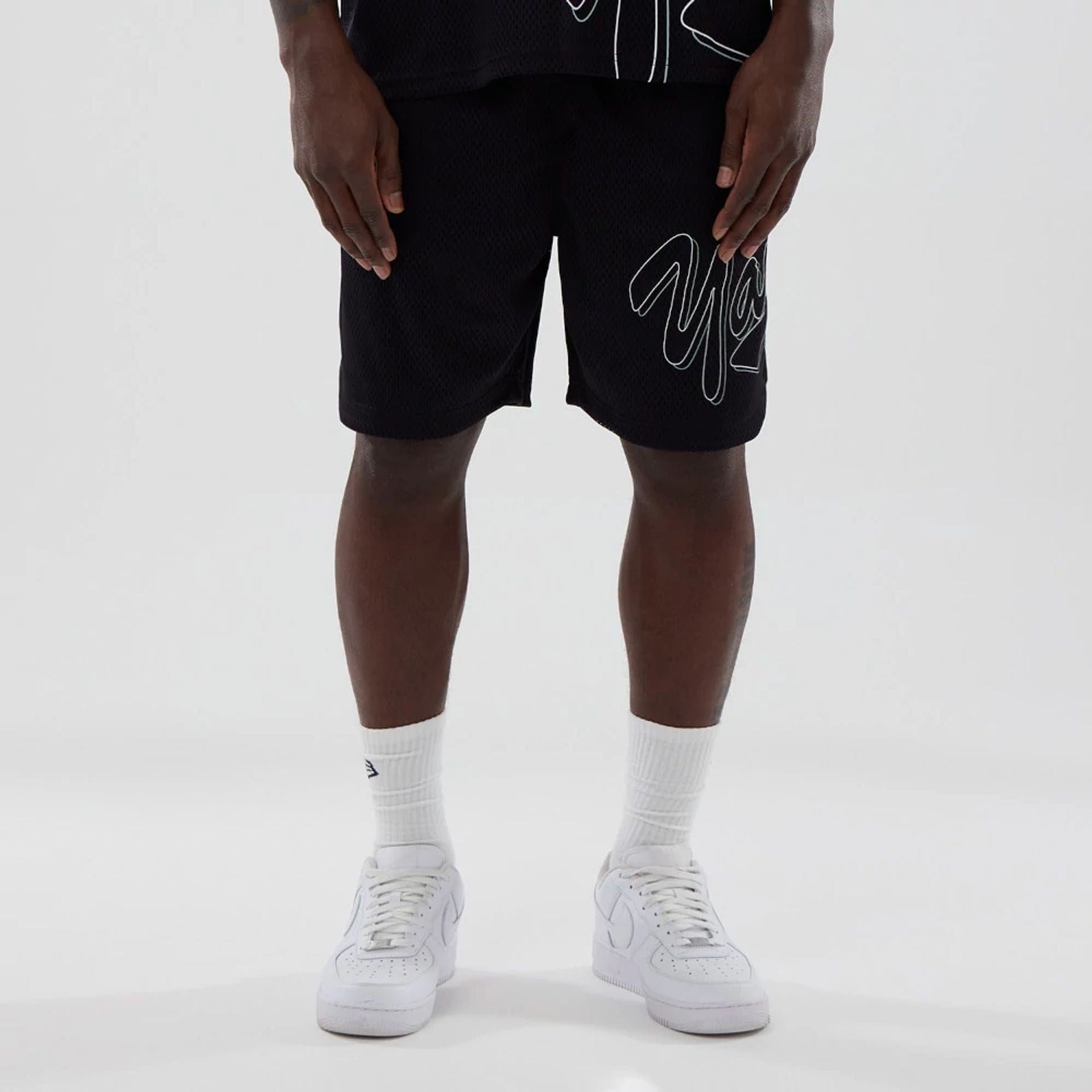 The model is wearing this MLB Mix League New York Yankees Oversized Mesh Shorts in black. 6