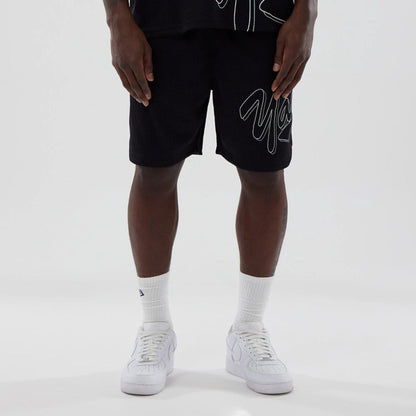 The model is wearing this MLB Mix League New York Yankees Oversized Mesh Shorts in black. 6