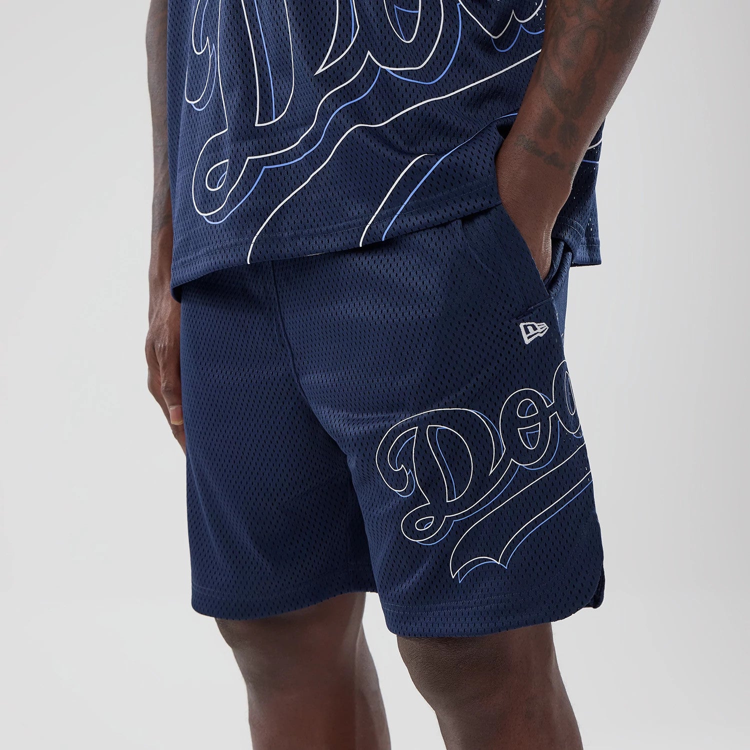 The model is wearing this MLB Mix League LA Dodgers Oversized Mesh Shorts in blue. 3