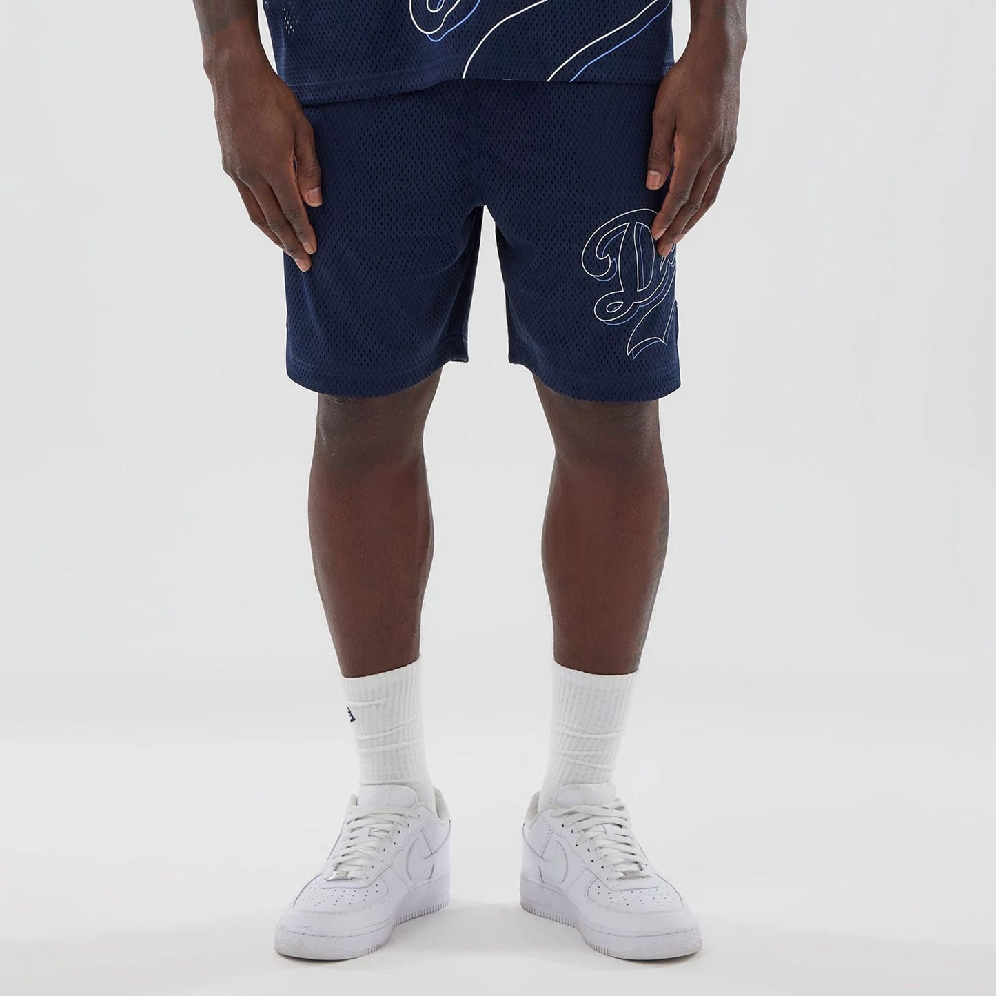 The model is wearing this MLB Mix League LA Dodgers Oversized Mesh Shorts in blue. 1