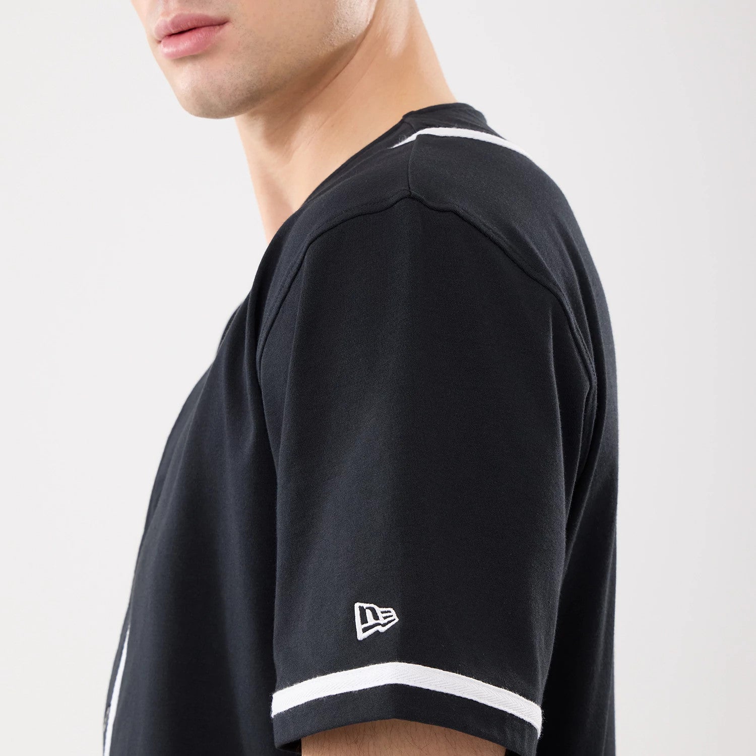 The model is wearing this New Era Basic Jersey in black. 4