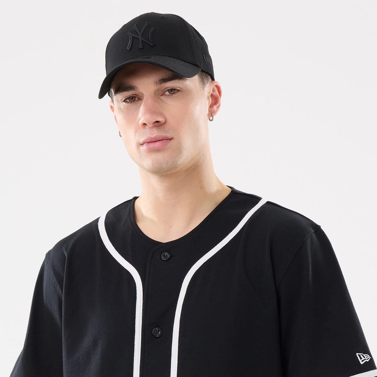 The model is wearing this New Era Basic Jersey in black. 7