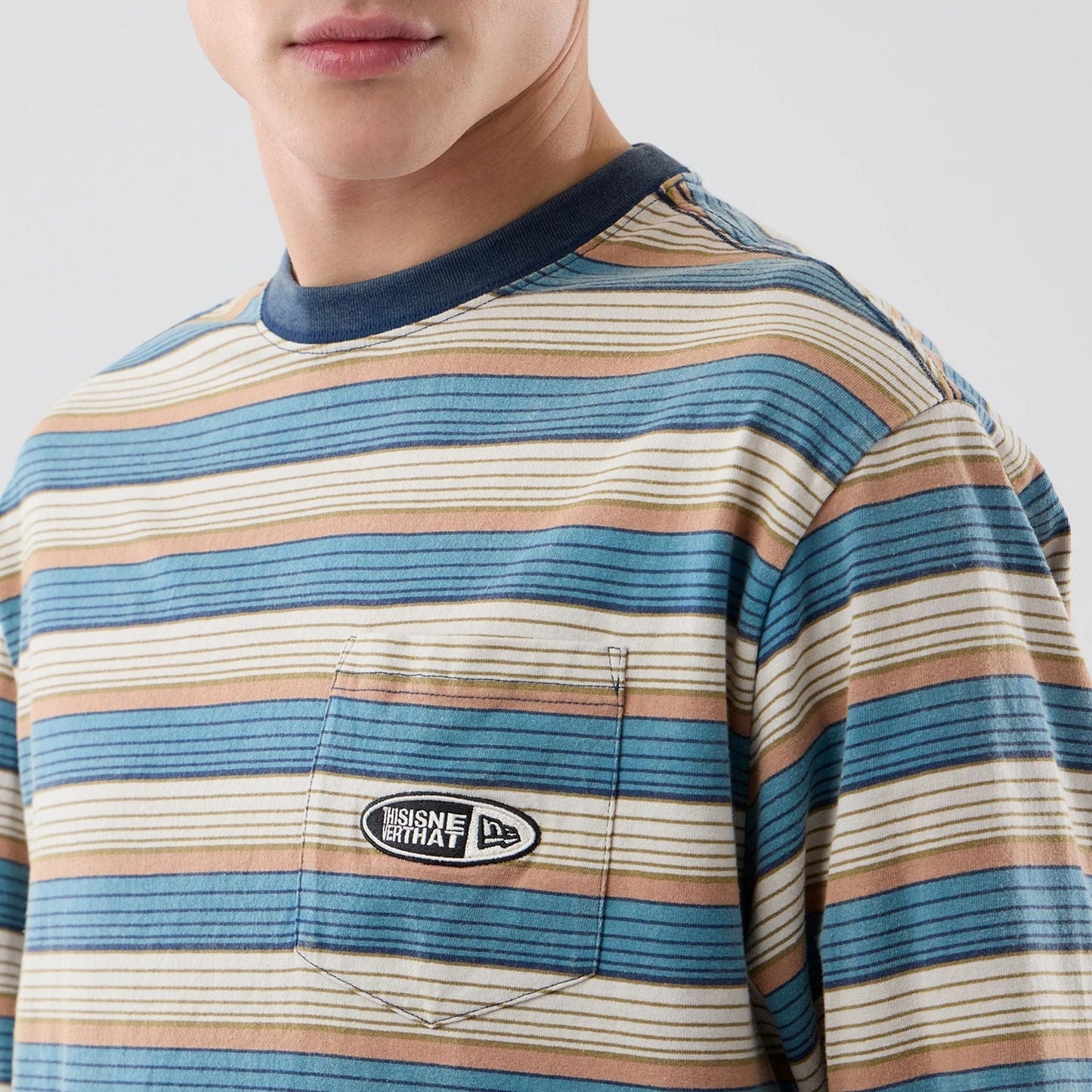 The model is wearing this Thisisneverthat X New Era Border Long Sleeve T-Shirt in beige. 3