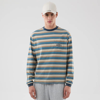 The model is wearing this Thisisneverthat X New Era Border Long Sleeve T-Shirt in beige. 1