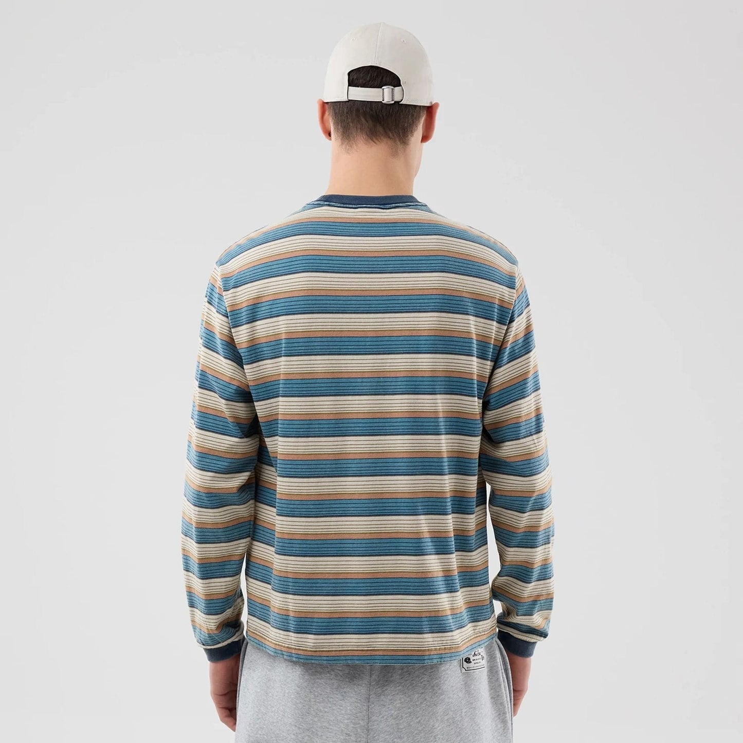The model is wearing this Thisisneverthat X New Era Border Long Sleeve T-Shirt in beige. 2