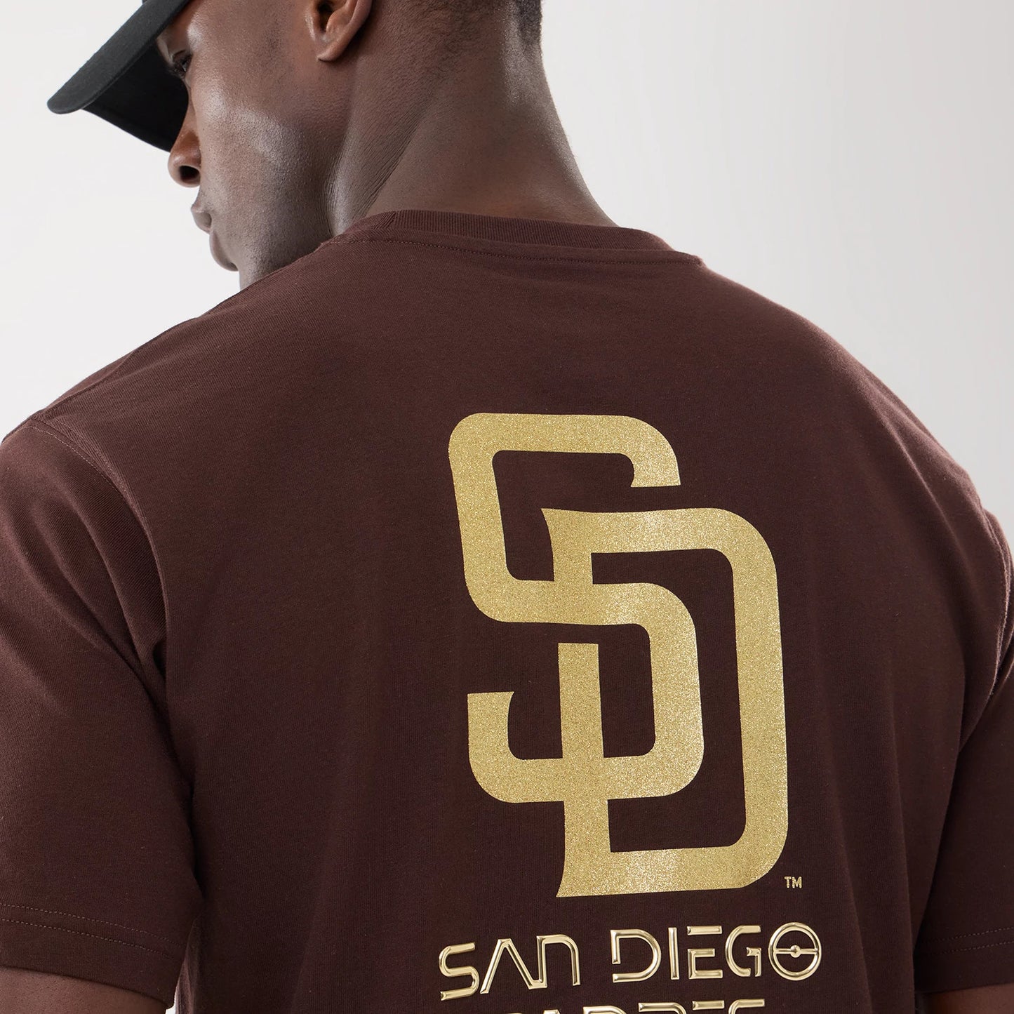 The model is wearing this Hajime Sorayama X MLB San Diego Padres T-Shirt in Dark Brown. 4