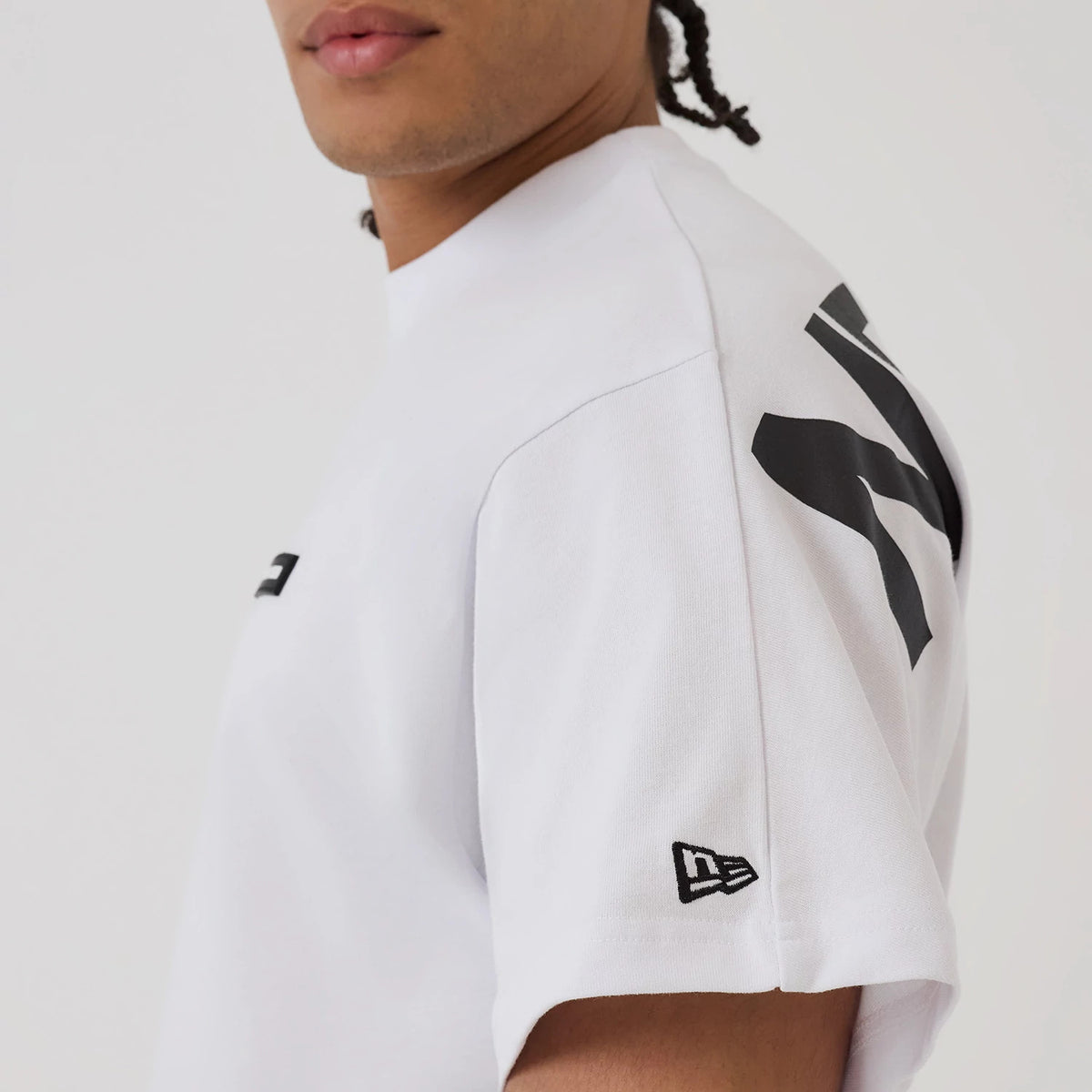 The model is wearing this New Era Distressed T-Shirt in white. 6