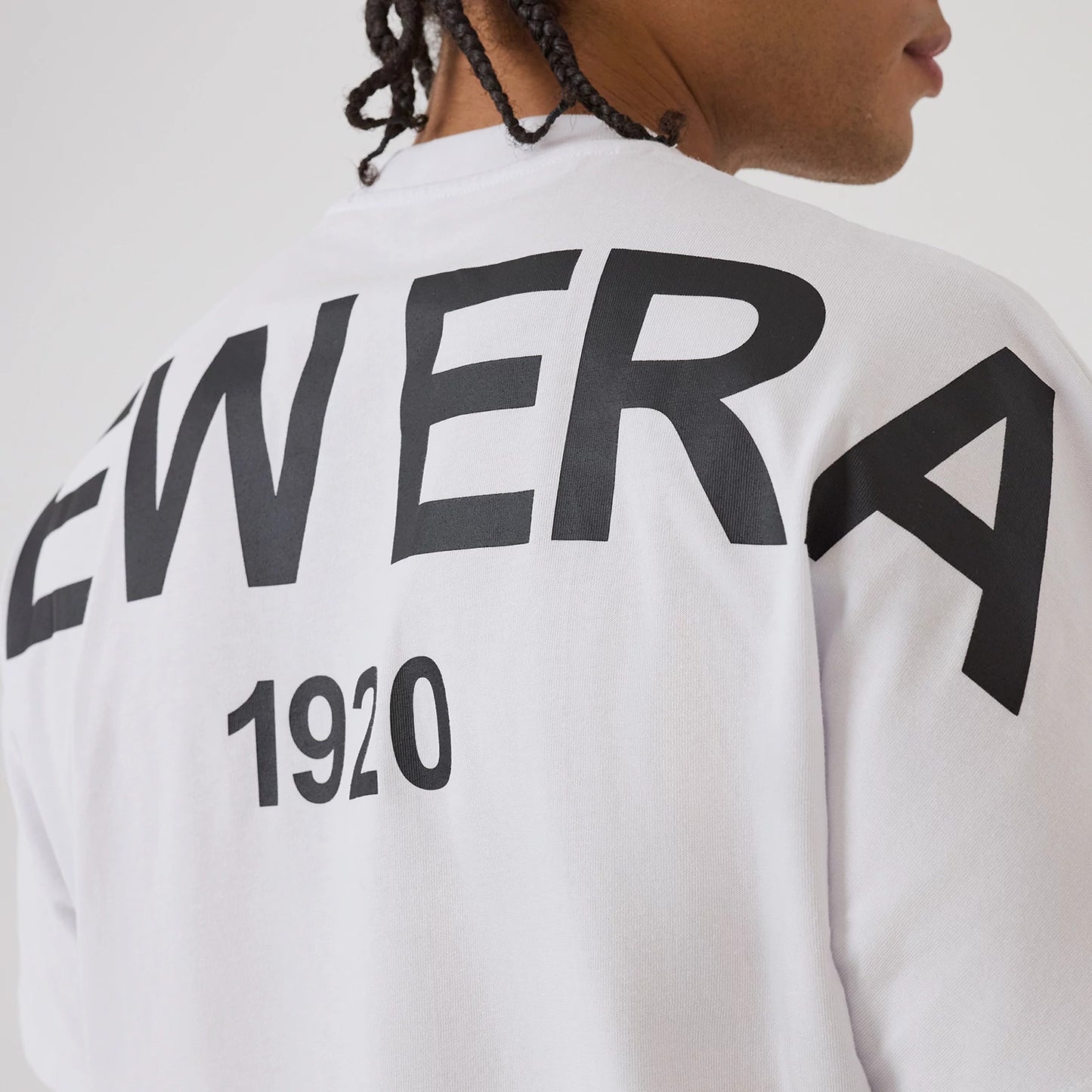 The model is wearing this New Era Distressed T-Shirt in white. 3