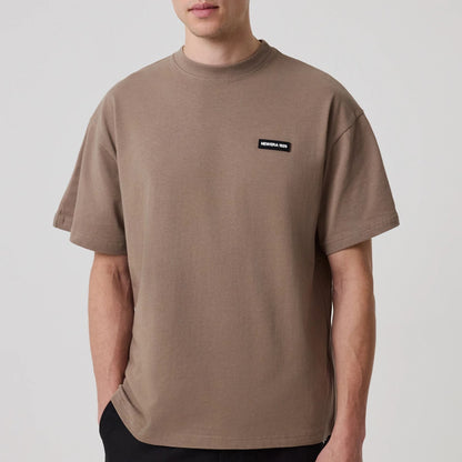 The model is wearing this New Era Distressed T-Shirt in Brown. 6