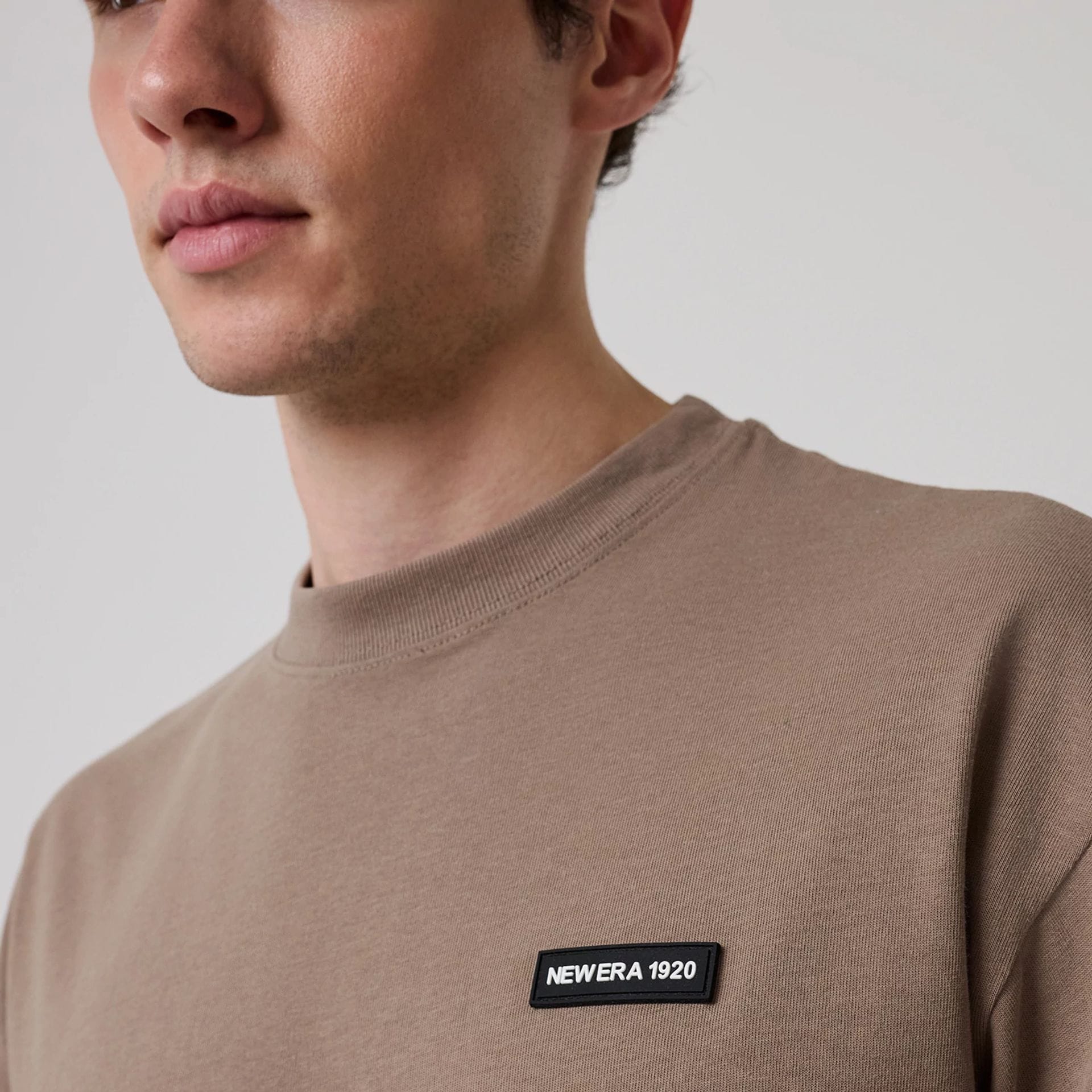 The model is wearing this New Era Distressed T-Shirt in Brown. 4