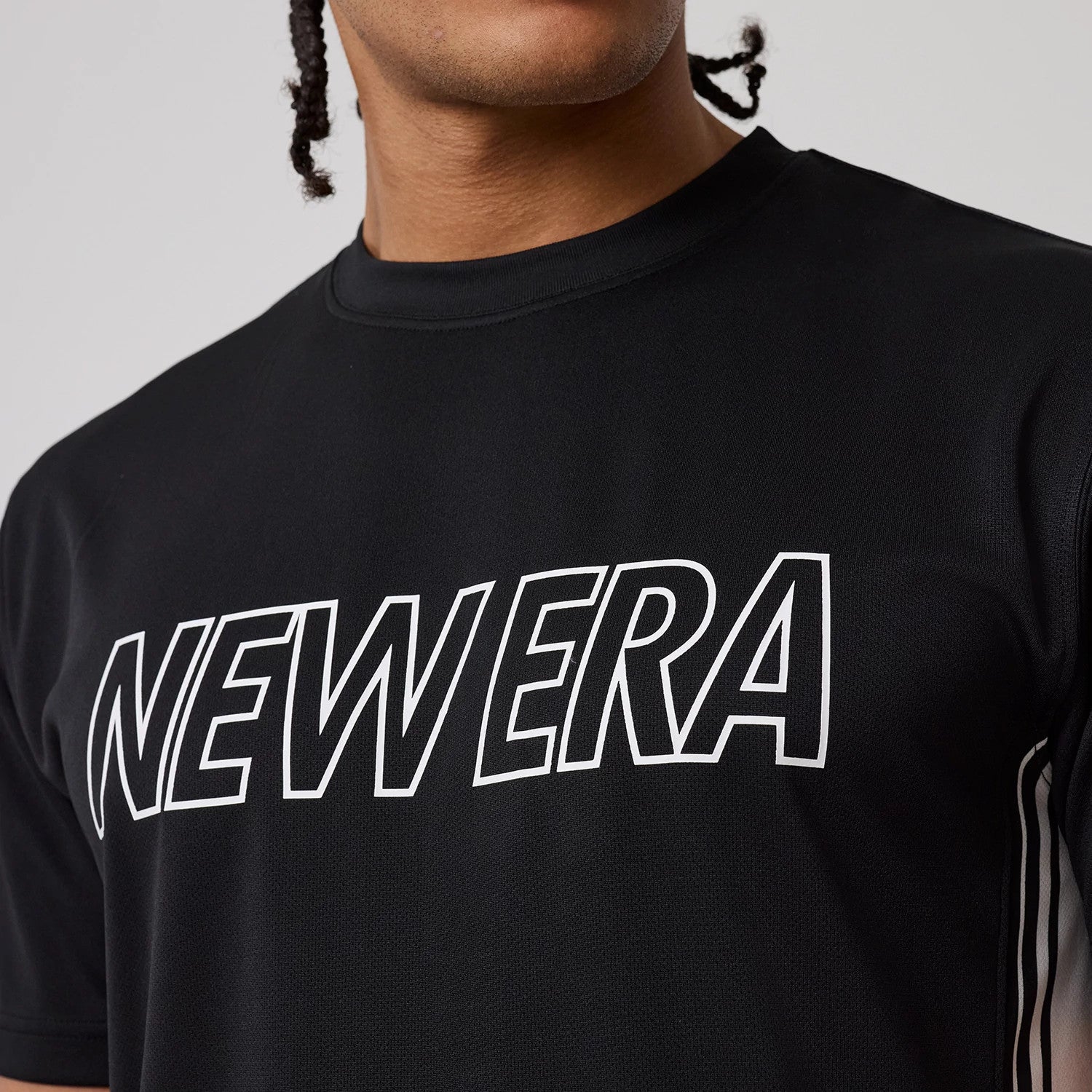 The model is wearing this New Era Mesh T-Shirt in black. 3