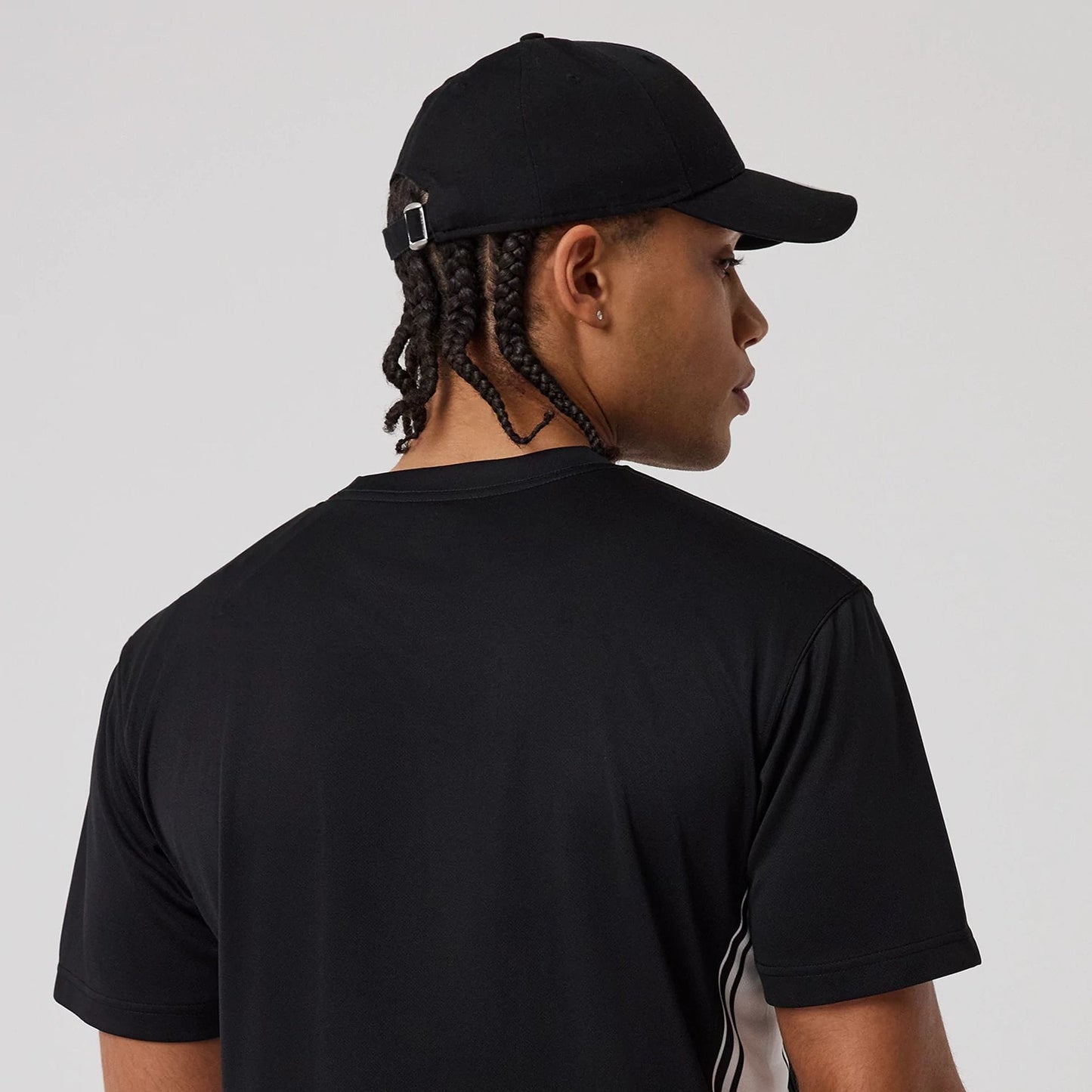 The model is wearing this New Era Mesh T-Shirt in black. 7