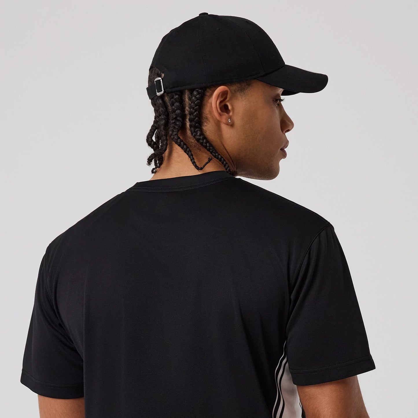 The model is wearing this New Era Mesh T-Shirt in black. 7