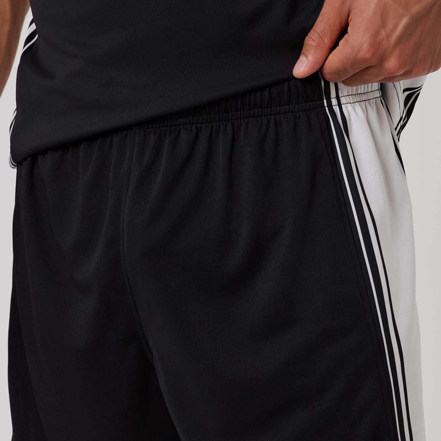 The model is wearing this New Era Mesh Shorts in black. 6