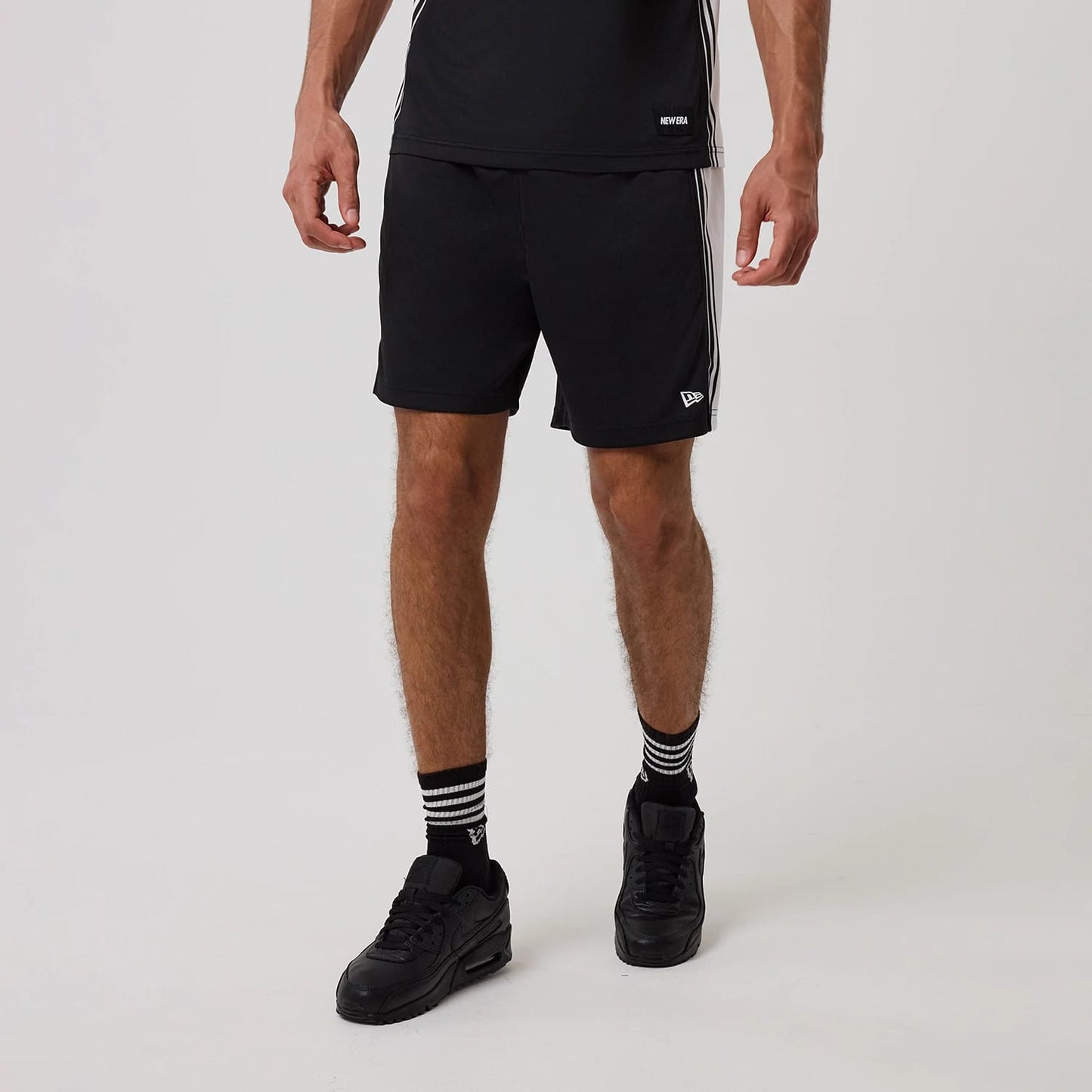 The model is wearing this New Era Mesh Shorts in black. 1