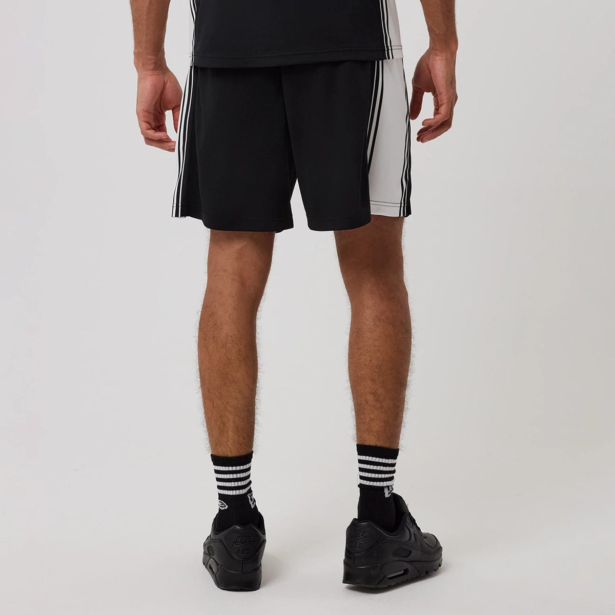 The model is wearing this New Era Mesh Shorts in black. 2