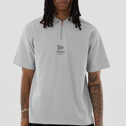 The model is wearing this New Era Seersucker Polo T-Shirt in grey. 3