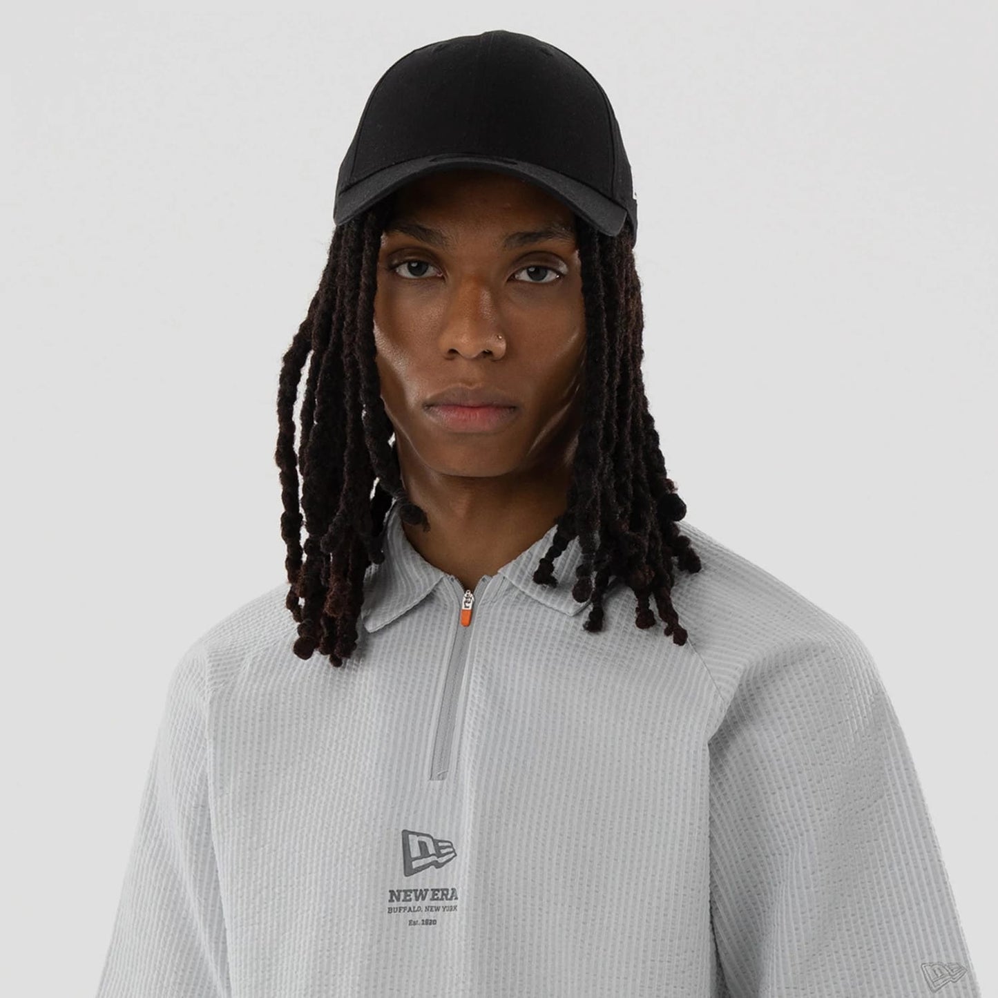 The model is wearing this New Era Seersucker Polo T-Shirt in grey. 7