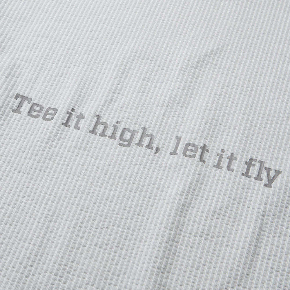 The model is wearing this New Era Seersucker Polo T-Shirt in grey. 8