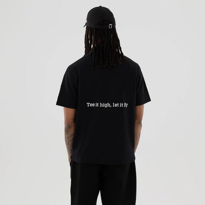 The model is wearing this New Era Seersucker Polo T-Shirt in black. 2