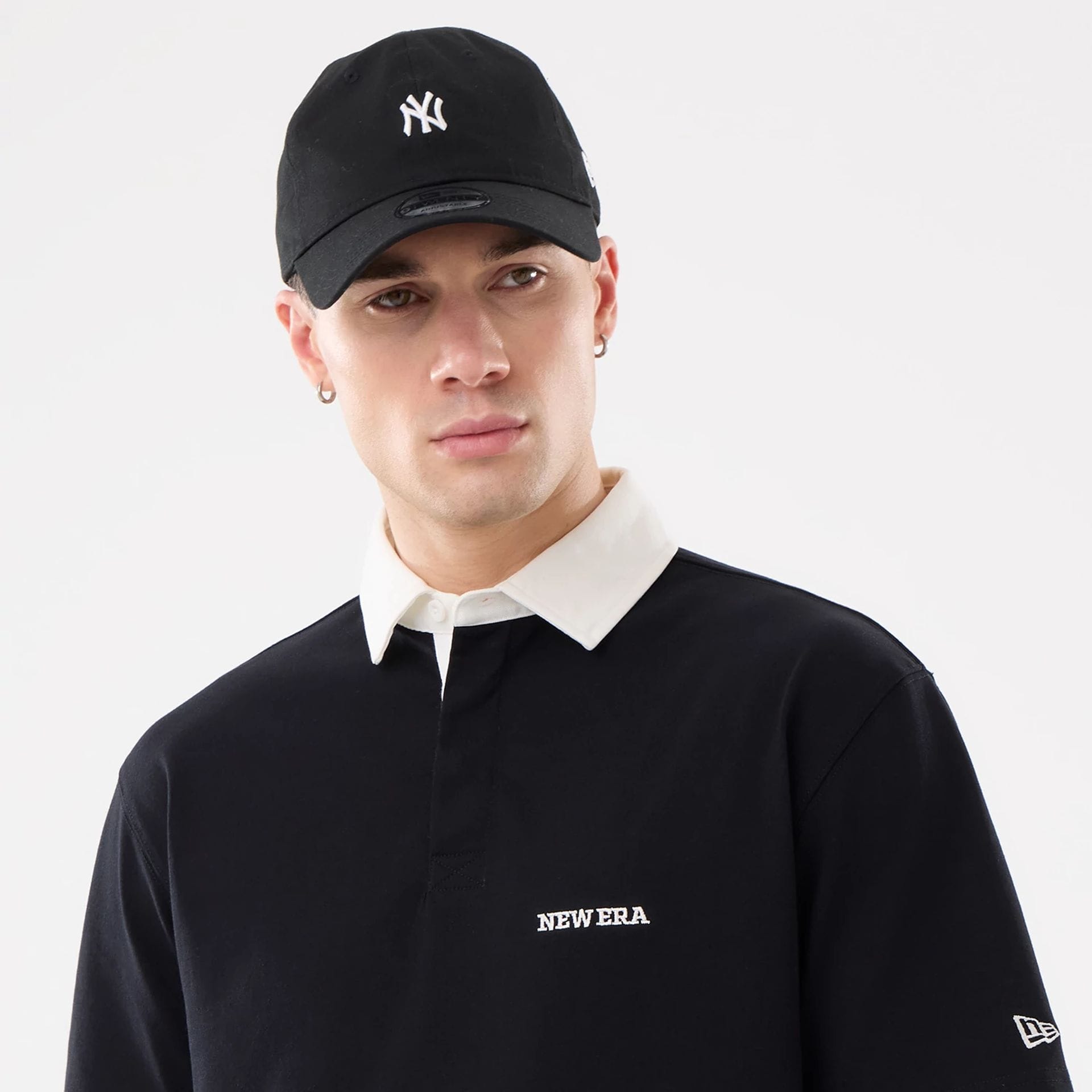 The model is wearing this New Era Short Sleeve Rugby Shirt in black. 6
