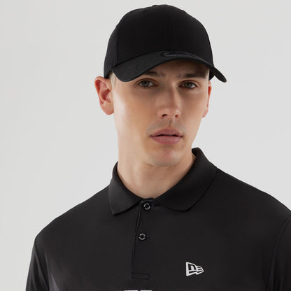 The model is wearing this New Era Grid Polo T-Shirt in black. 7