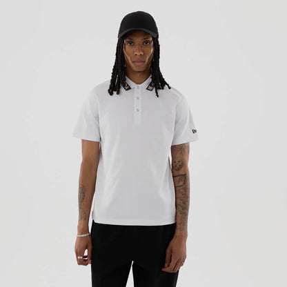The model is wearing this New Era Kanoko Polo T-Shirt in white. 1
