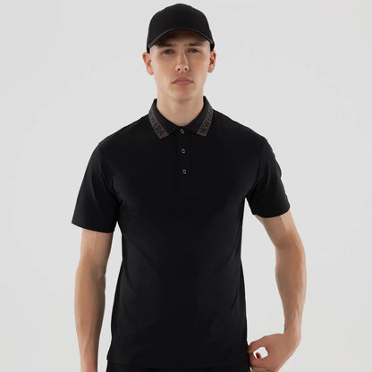 The model is wearing this New Era Kanoko Polo T-Shirt in black. 3