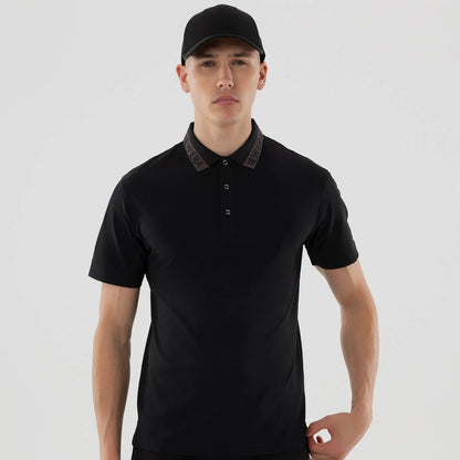 The model is wearing this New Era Kanoko Polo T-Shirt in black. 3